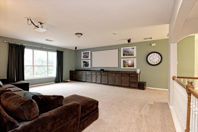 living room featuring baseboards, light colored carpet, and visible vents