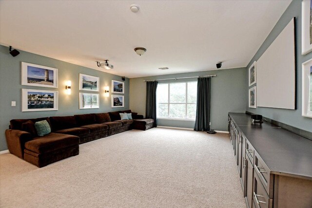 carpeted living room with baseboards