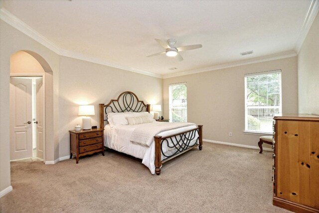 bedroom featuring arched walkways, multiple windows, light carpet, and visible vents