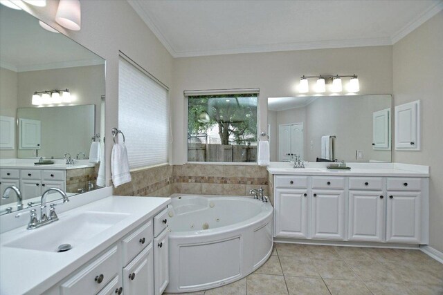 full bath featuring a sink, tile patterned floors, crown molding, and a tub with jets