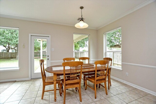 dining space featuring light tile patterned floors, baseboards, ornamental molding, and a healthy amount of sunlight