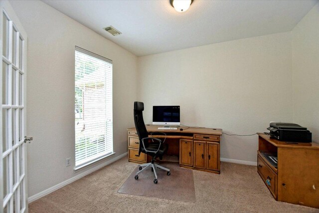 office area with light colored carpet, baseboards, and visible vents