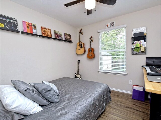 bedroom featuring baseboards, a ceiling fan, and wood finished floors