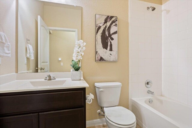 full bath with vanity, toilet, and  shower combination