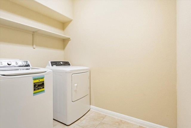 1504 Maier Dr, Pflugerville, TX 78660 - laundry room featuring washer and clothes dryer, baseboards, and light tile patterned flooring