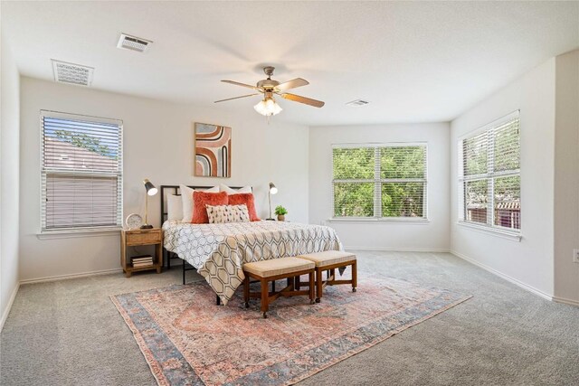 carpeted bedroom featuring baseboards and visible vents