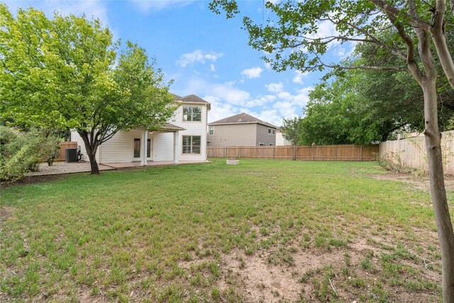 view of yard with a patio, central AC unit, and a fenced backyard