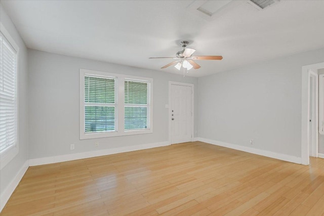 empty room with baseboards, light wood-style floors, and ceiling fan