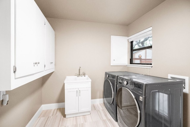 2100 Four Oaks Ln, Austin, TX 78704 - laundry room with separate washer and dryer, cabinet space, and baseboards