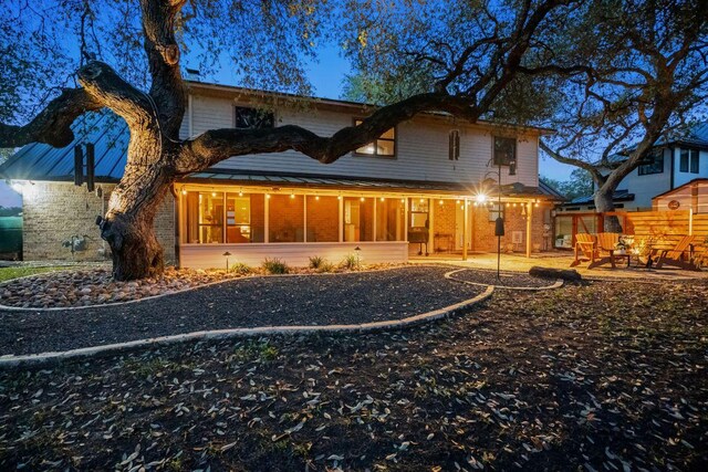 back of house featuring a sunroom and a patio area