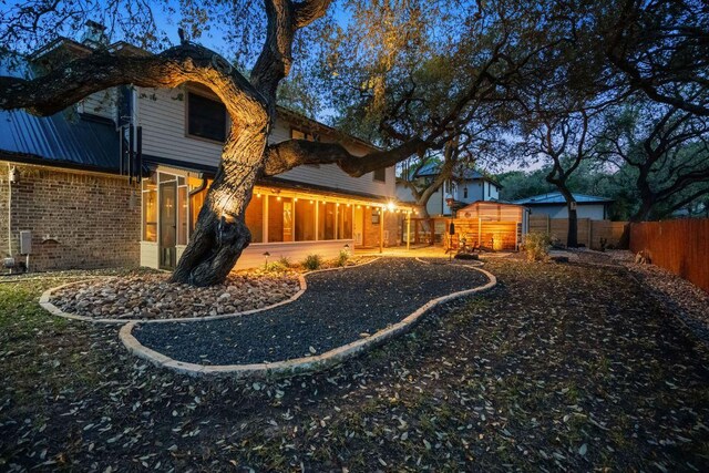rear view of house with brick siding and a fenced backyard