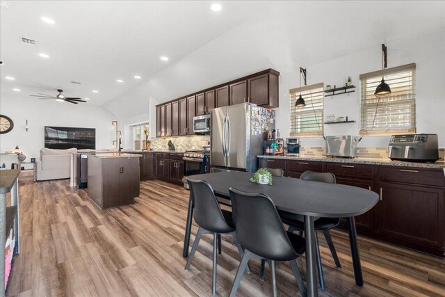 dining area with visible vents, recessed lighting, lofted ceiling, and wood finished floors