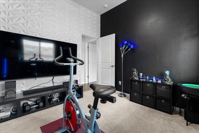 workout room featuring carpet floors and baseboards