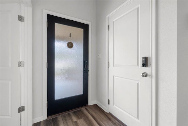 foyer entrance featuring baseboards and dark wood-style flooring