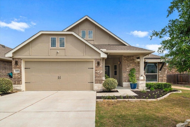 view of front of home with brick siding, driveway, fence, and a front lawn