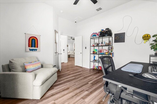 office space with a ceiling fan, visible vents, and wood finished floors
