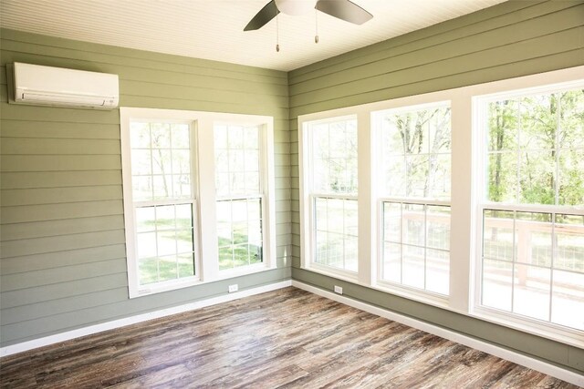 3477 Bradley Ln, Brenham, TX 77833 - unfurnished sunroom with baseboards, a wall unit AC, and wood finished floors