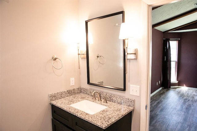 3477 Bradley Ln, Brenham, TX 77833 - bathroom featuring lofted ceiling with beams, wood finished floors, and vanity