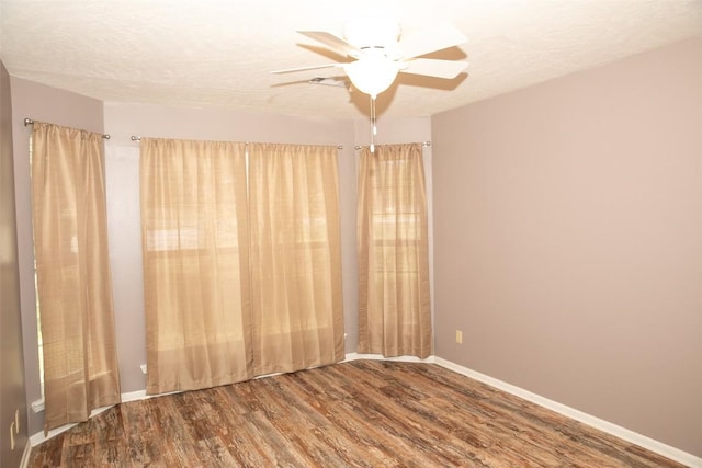 3477 Bradley Ln, Brenham, TX 77833 - spare room with baseboards, ceiling fan, a textured ceiling, and wood finished floors