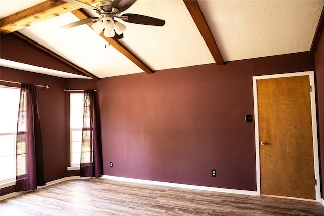 3477 Bradley Ln, Brenham, TX 77833 - spare room featuring ceiling fan, baseboards, vaulted ceiling with beams, and wood finished floors