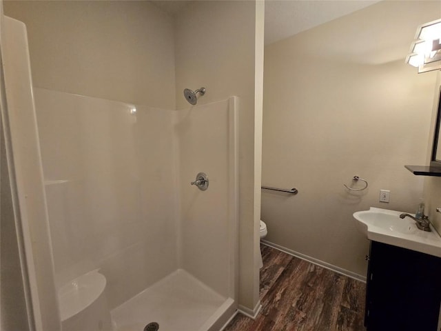 3477 Bradley Ln, Brenham, TX 77833 - bathroom with vanity, wood finished floors, toilet, and a shower stall