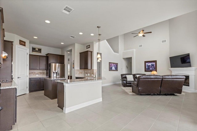 1800 Erie Dr, Leander, TX 78641 - kitchen featuring stainless steel fridge with ice dispenser, open floor plan, dark brown cabinets, a ceiling fan, and recessed lighting
