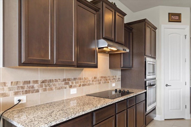 1800 Erie Dr, Leander, TX 78641 - kitchen featuring under cabinet range hood, stainless steel appliances, dark brown cabinets, and backsplash