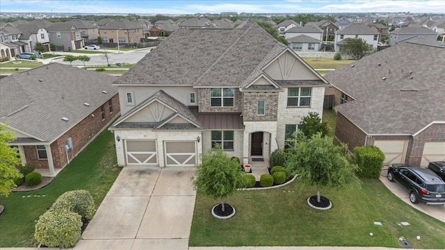 1800 Erie Dr, Leander, TX 78641 - view of front of property with a residential view, concrete driveway, stone siding, a front yard, and stucco siding