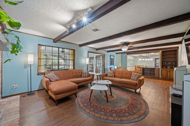 3909 Alderwood Ln, Temple, TX 76502 - living room with a textured ceiling, wood finished floors, beamed ceiling, bar, and a ceiling fan