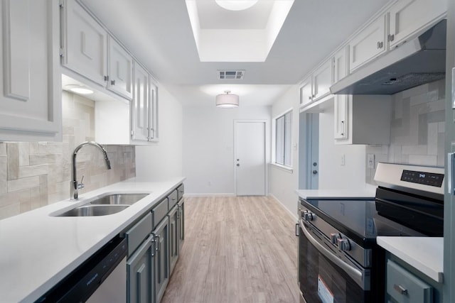 3608 Branigan Ln, Austin, TX 78759 - kitchen with visible vents, stainless steel appliances, a sink, light countertops, and under cabinet range hood