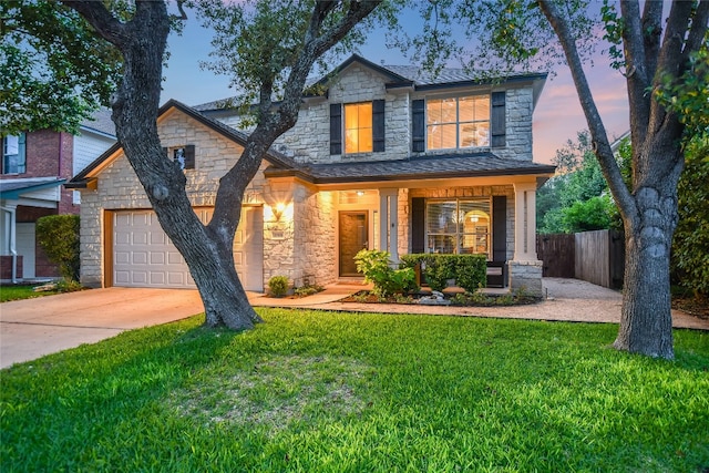 3768 Turetella Dr, Round Rock, TX 78681 - traditional-style house featuring fence, stone siding, a yard, an attached garage, and driveway