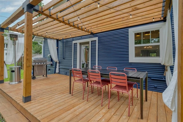 wooden deck featuring outdoor dining space, a grill, and a pergola