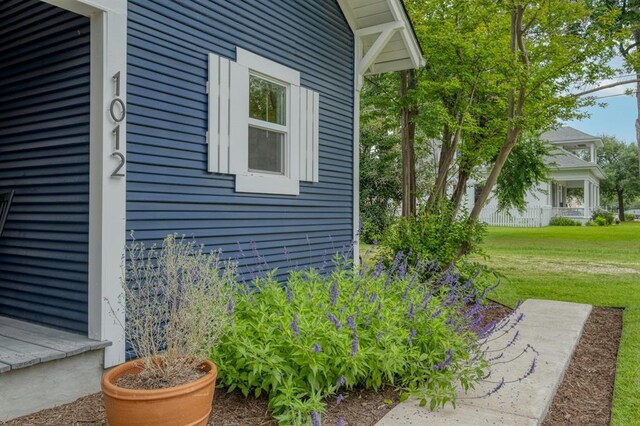 view of side of property with a lawn