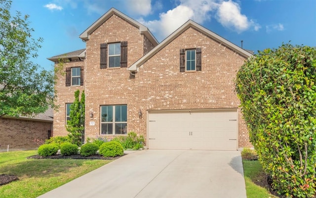 traditional-style home featuring concrete driveway and brick siding
