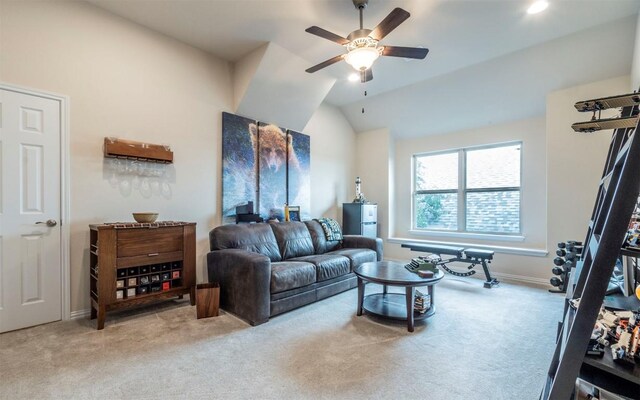 carpeted living area featuring baseboards, ceiling fan, and vaulted ceiling