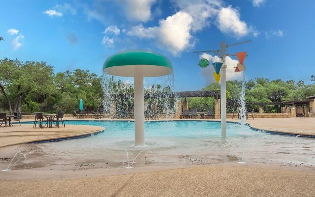 community pool with a patio area