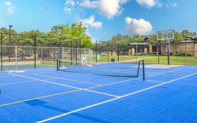 view of tennis court featuring fence and community basketball court