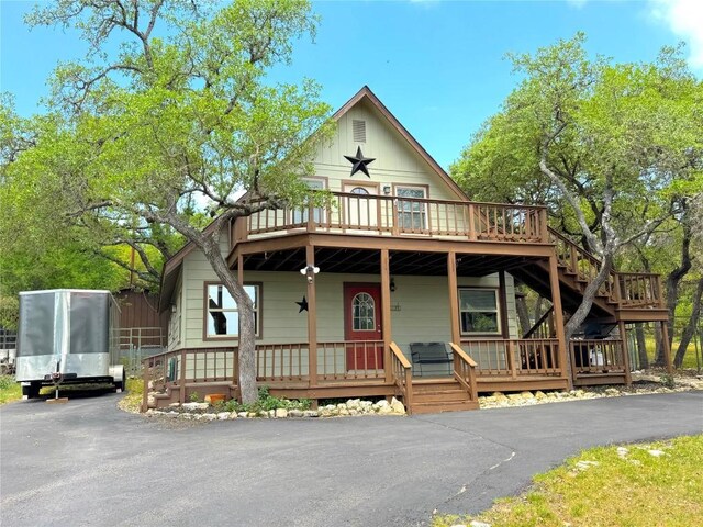 209 Lake Frst, Canyon Lake, TX 78133 - view of front facade featuring a porch, board and batten siding, and stairs