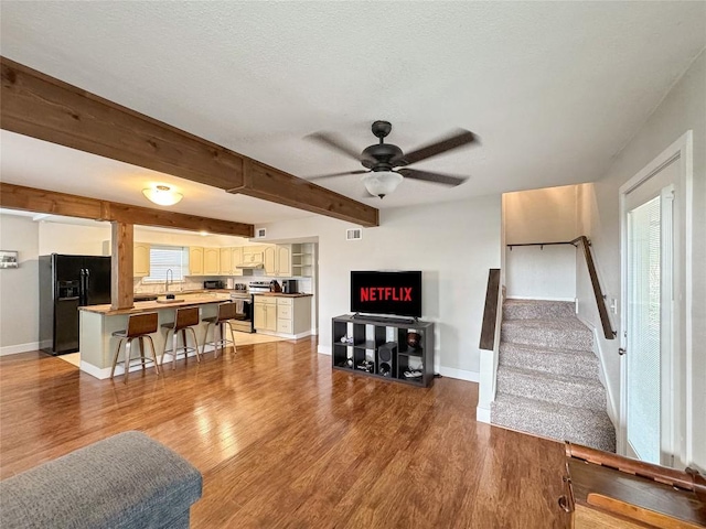 209 Lake Frst, Canyon Lake, TX 78133 - living room featuring baseboards, ceiling fan, wood finished floors, and beamed ceiling
