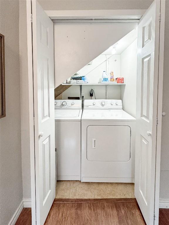209 Lake Frst, Canyon Lake, TX 78133 - laundry room featuring laundry area, washing machine and dryer, and wood finished floors