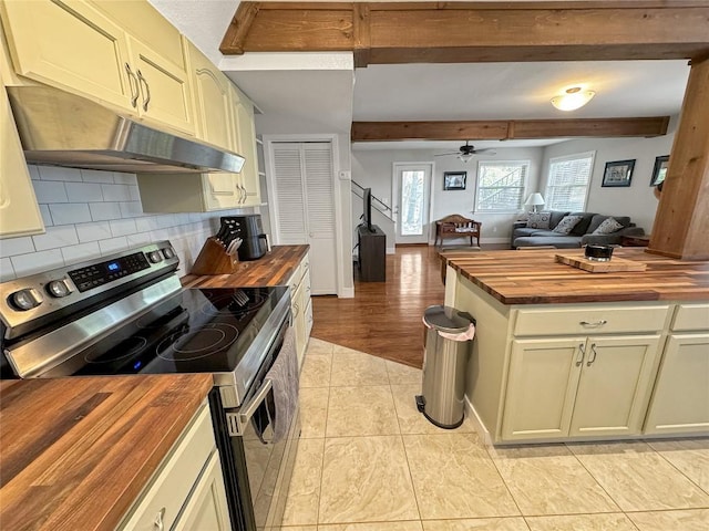 209 Lake Frst, Canyon Lake, TX 78133 - kitchen with stainless steel range with electric cooktop, a ceiling fan, backsplash, under cabinet range hood, and butcher block counters