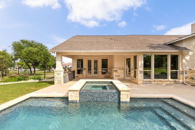 view of pool with fence, a patio, french doors, a fenced in pool, and exterior kitchen