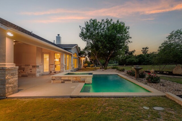 view of pool with a yard, a patio, and a pool with connected hot tub