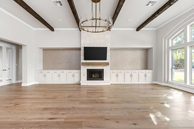 unfurnished living room featuring visible vents, beam ceiling, and an inviting chandelier