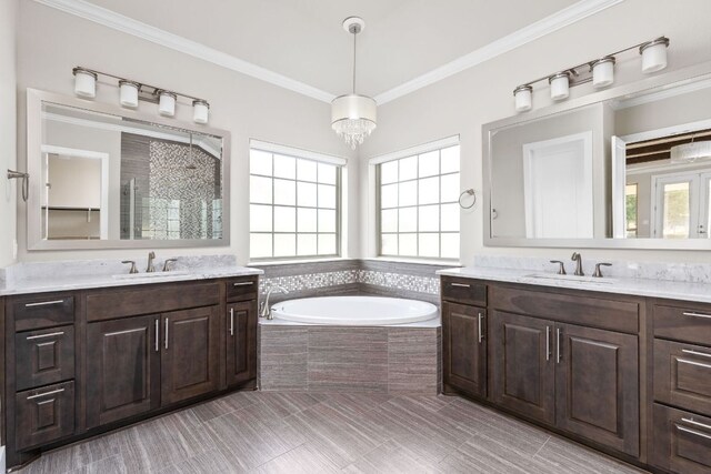 full bathroom with a garden tub, a sink, a stall shower, and two vanities