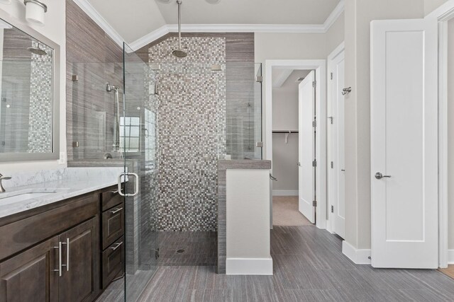 full bathroom with vanity, ornamental molding, wood finished floors, and a shower stall