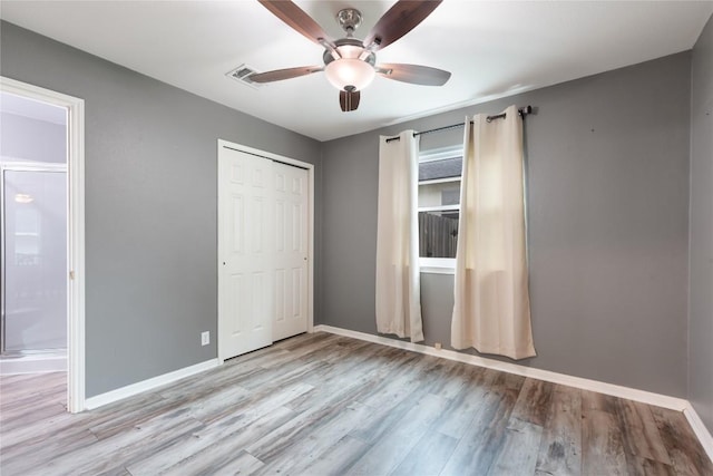 234 Saint Marys Dr, Hutto, TX 78634 - unfurnished bedroom featuring baseboards, ceiling fan, a closet, and wood finished floors
