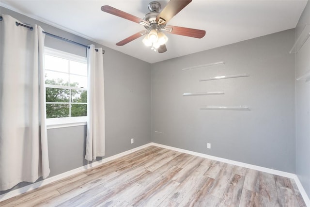 234 Saint Marys Dr, Hutto, TX 78634 - spare room with a ceiling fan, baseboards, and wood finished floors