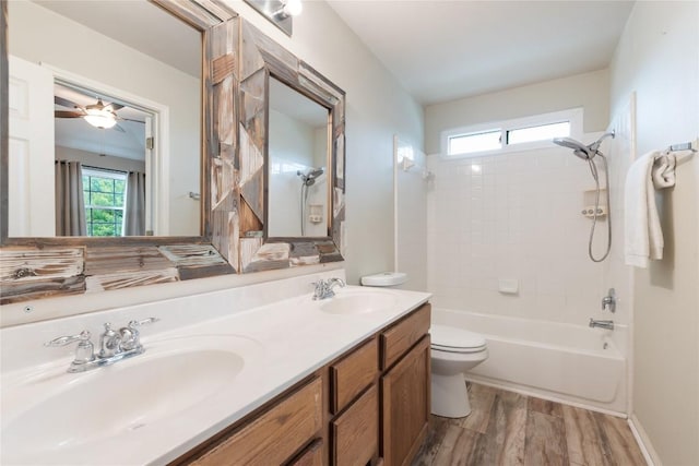 234 Saint Marys Dr, Hutto, TX 78634 - full bath featuring double vanity, toilet, a sink, and wood finished floors