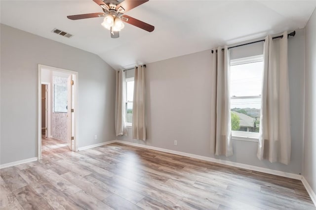 234 Saint Marys Dr, Hutto, TX 78634 - spare room with visible vents, light wood-style flooring, lofted ceiling, and a healthy amount of sunlight